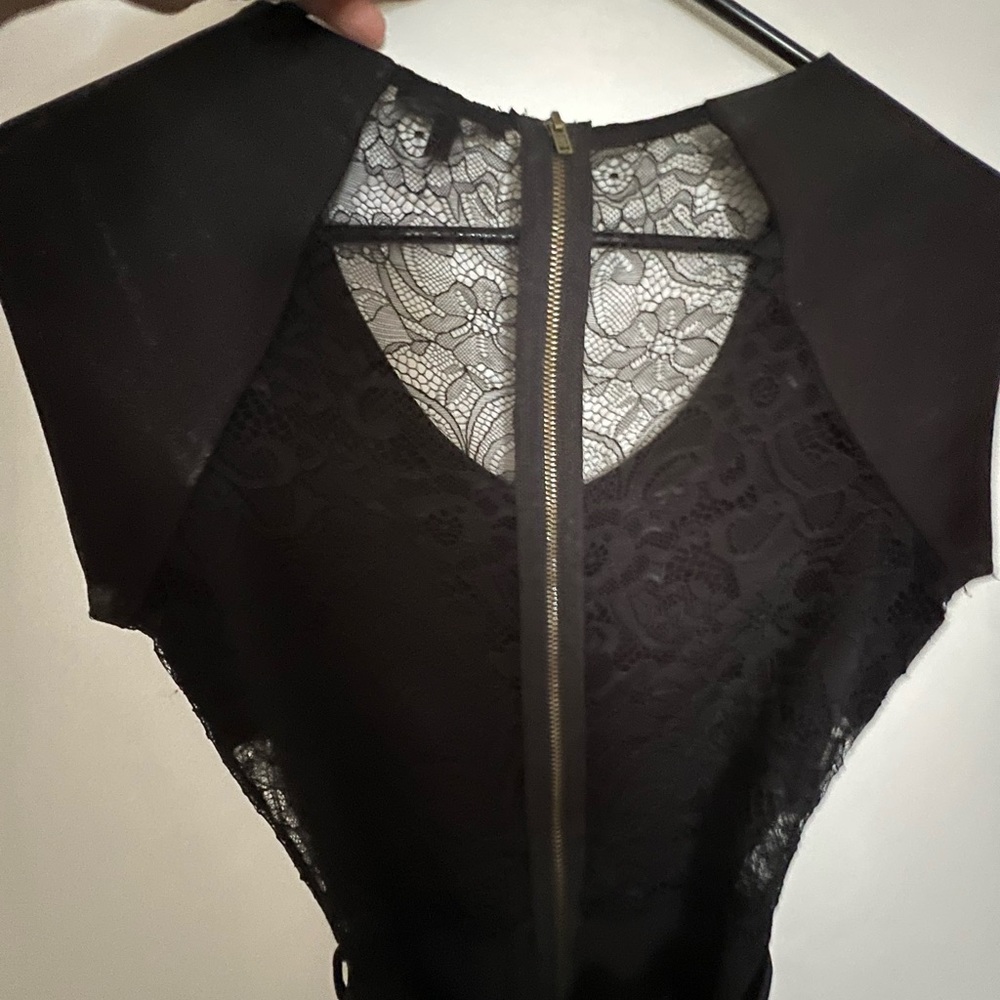 Cute black dress with cut-out lace details at side and back. Size small.